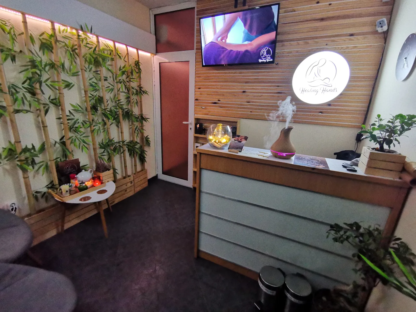 Reception and relaxation area at Healing Hands Studio with bamboo and greenery